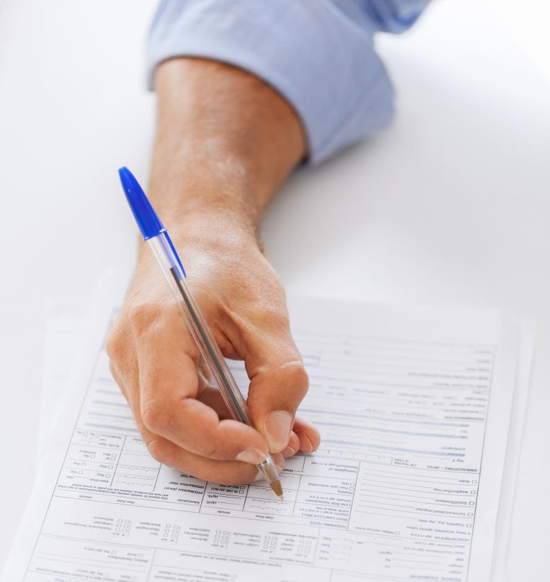 man filling tax form